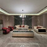 Cream Leather Sofa with Dark High-Gloss Wood Panels, Monogram Cushions and Metal Base Trim